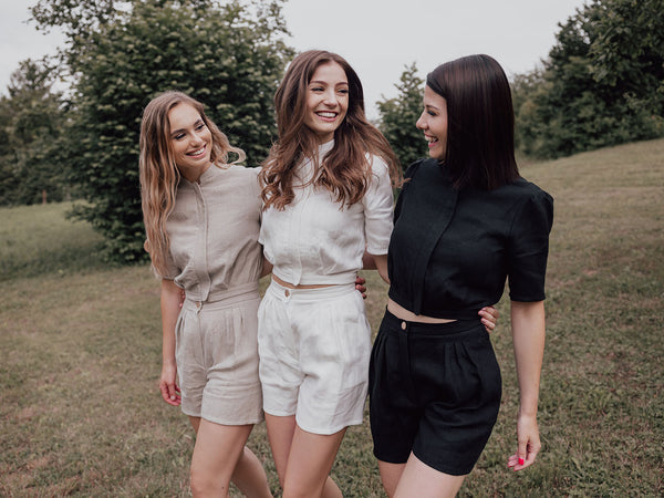 Three women walking and looking at each other joyfully in sustainable Czucz Studio clothes.