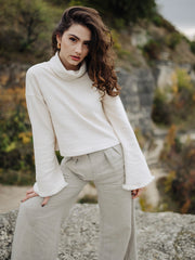 Fashion photo of girl in white organic cotton Czucz Studio sweater and linen pants