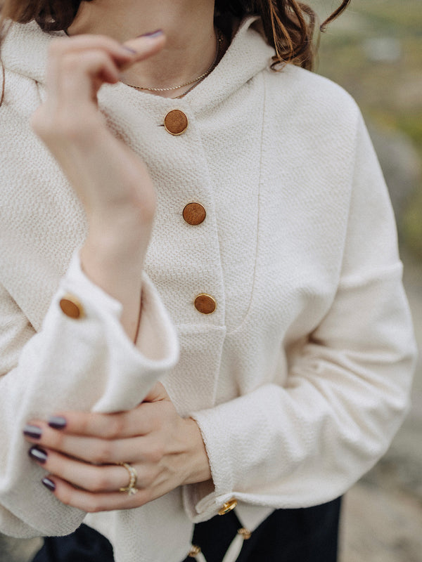 Close up fashion photo of organic cotton Czucz Studio Rime sweater with hood and buttons